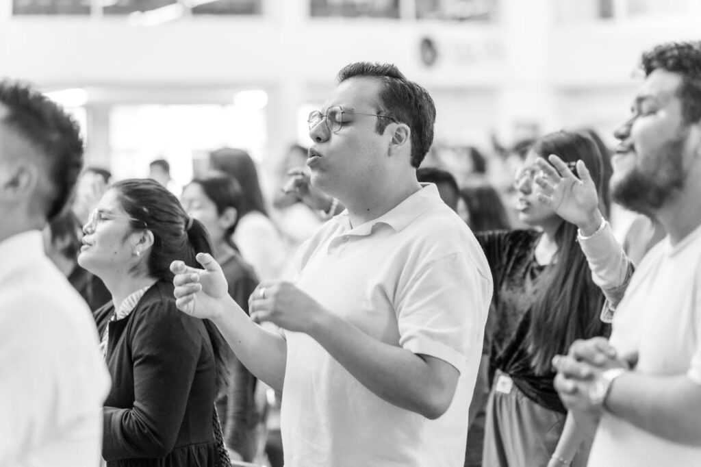 A group of people engaged in spiritual singing and prayer in Ciudad de México, conveying a sense of devotion and faith.